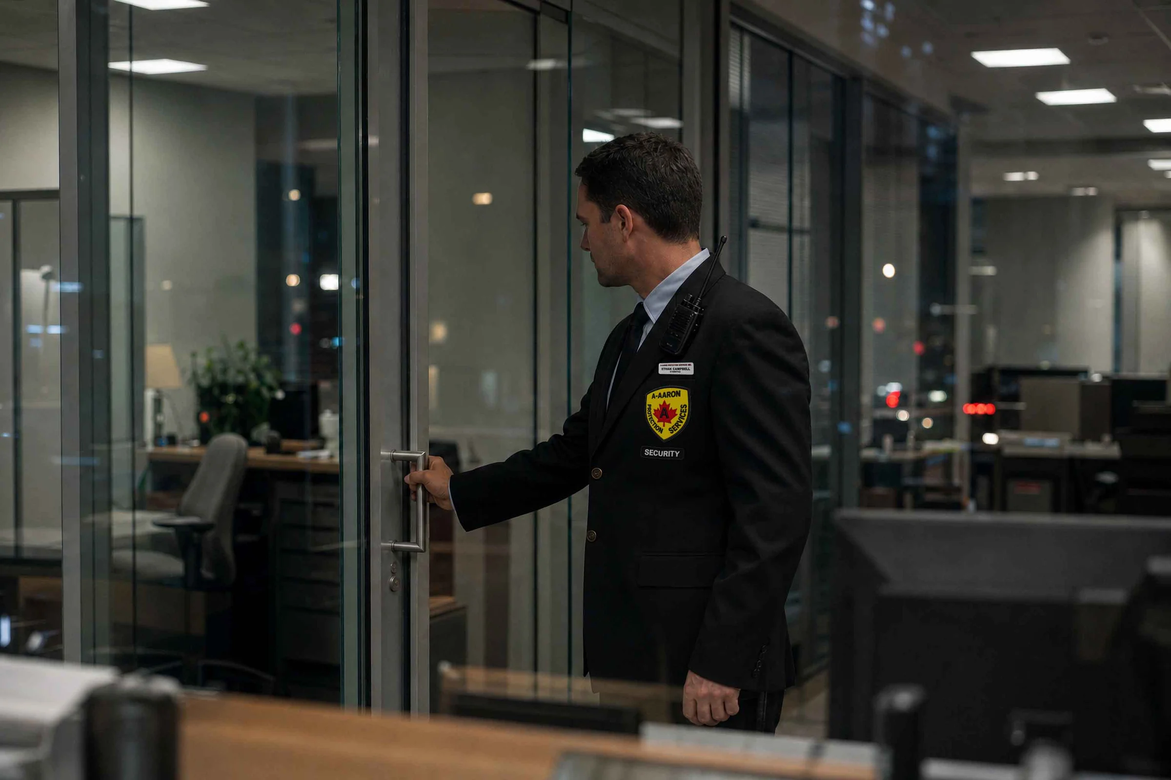 A-AARON guard checking an office door during an after-hours financial workplace patrol