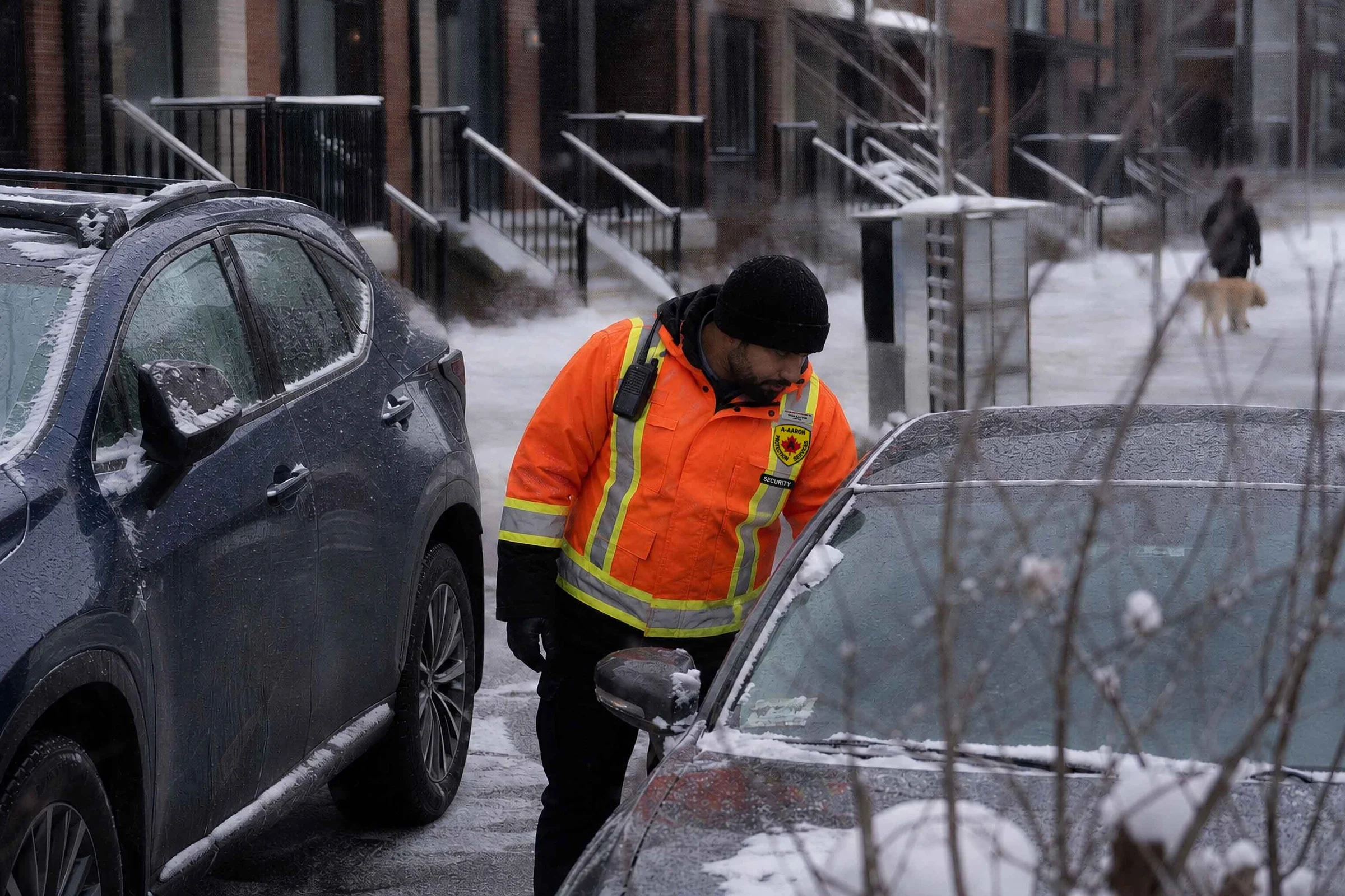 A-AARON guard checking a visitor permit through a vehicle windshield during a winter patrol